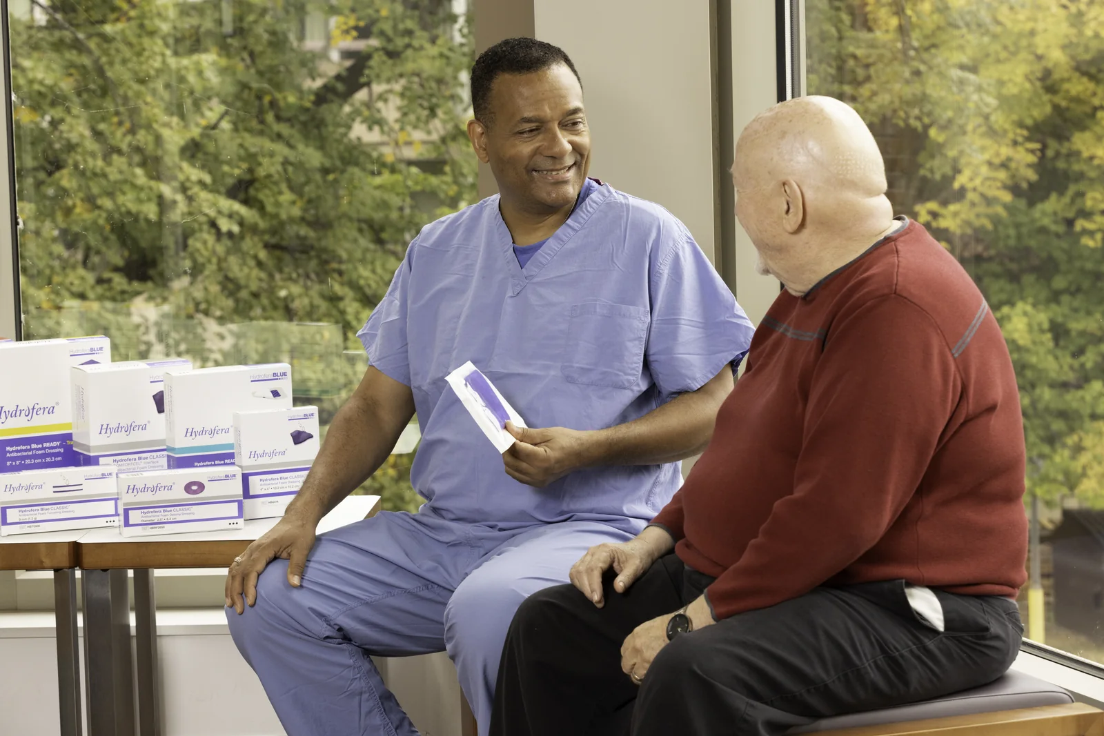 Clinician discussing Hydrofera Blue treatment with a patient