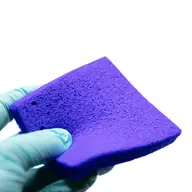 Clinician applying a Hydrofera Blue COMFORTCEL dressing